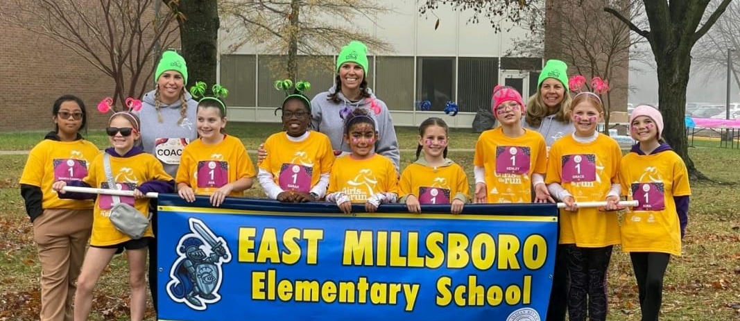 staff and students with a east millsboro elementary school sign