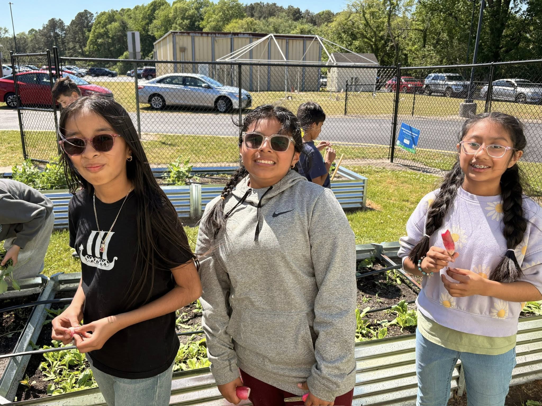 John M. Clayton Elementary girls posing in the garden