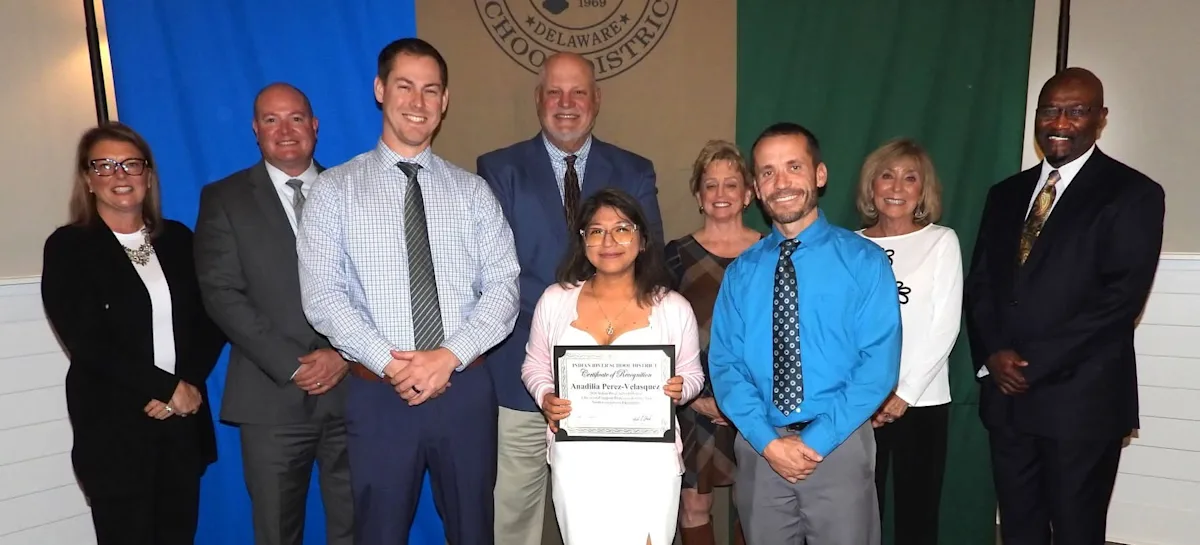 staff smiling for an award