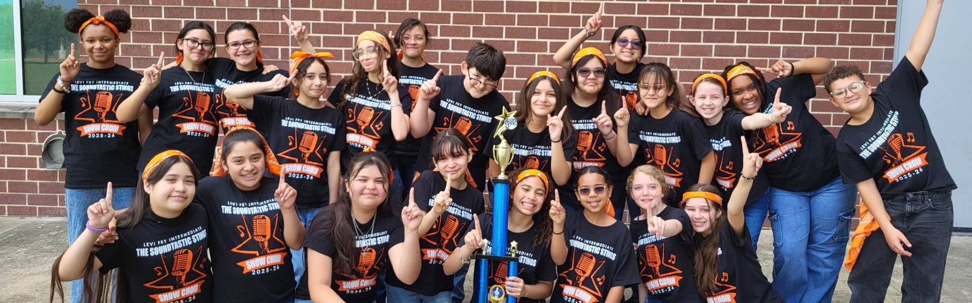 students pose with show choir trophy