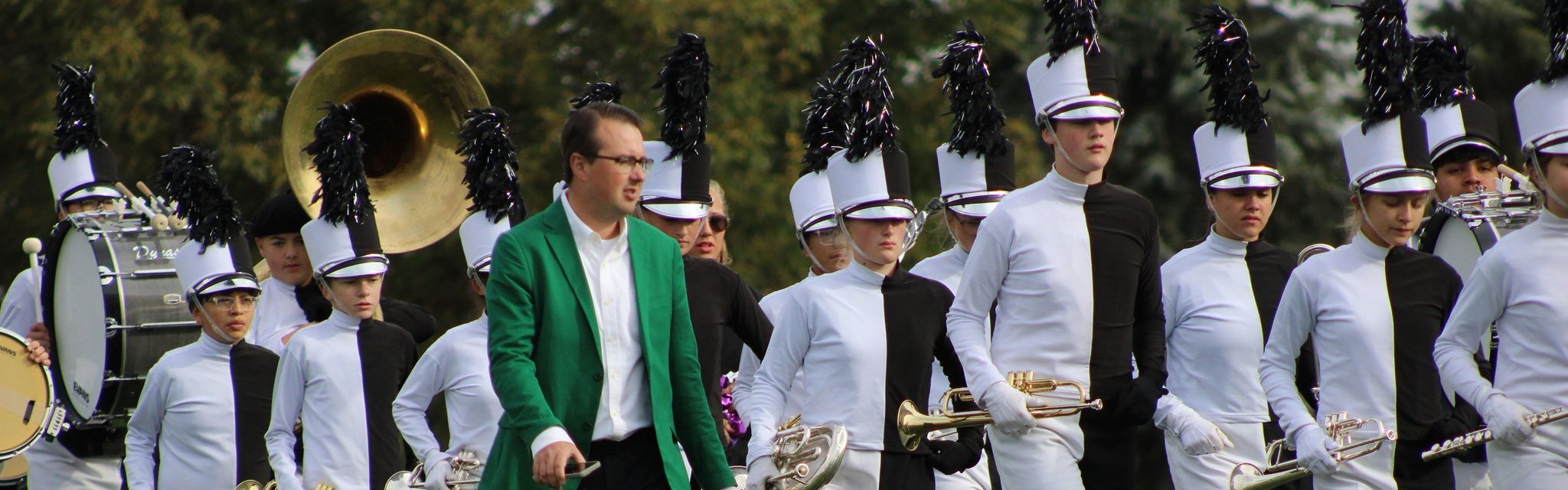 marching band students carrying instruments