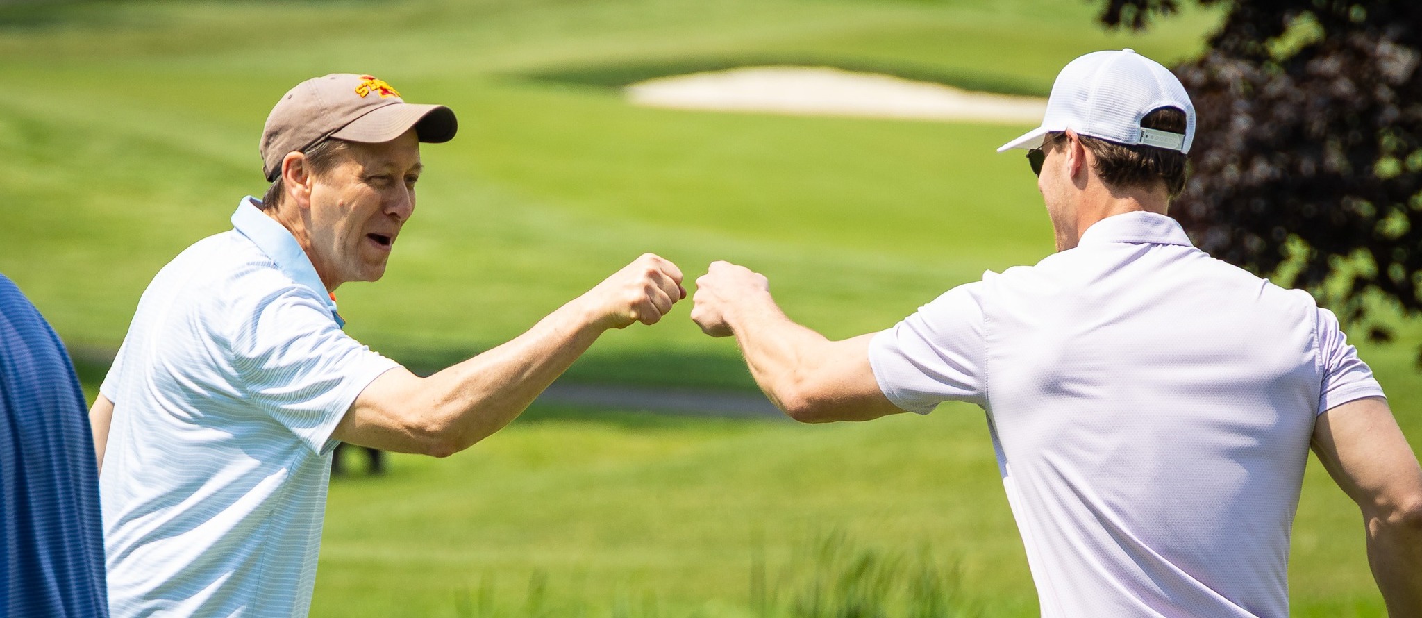 two golfers celebrate a good hit