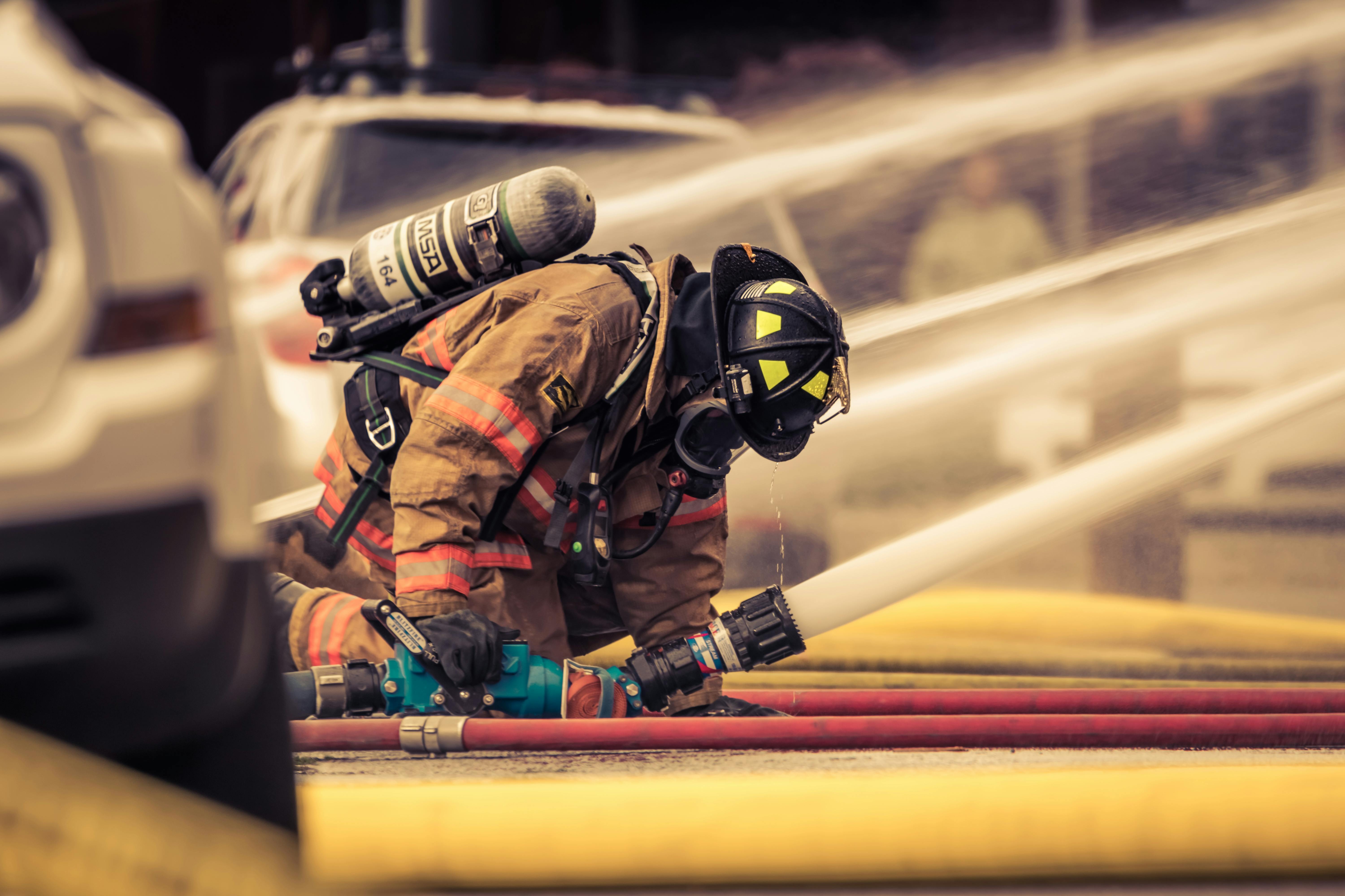 Firefighter with water hose.