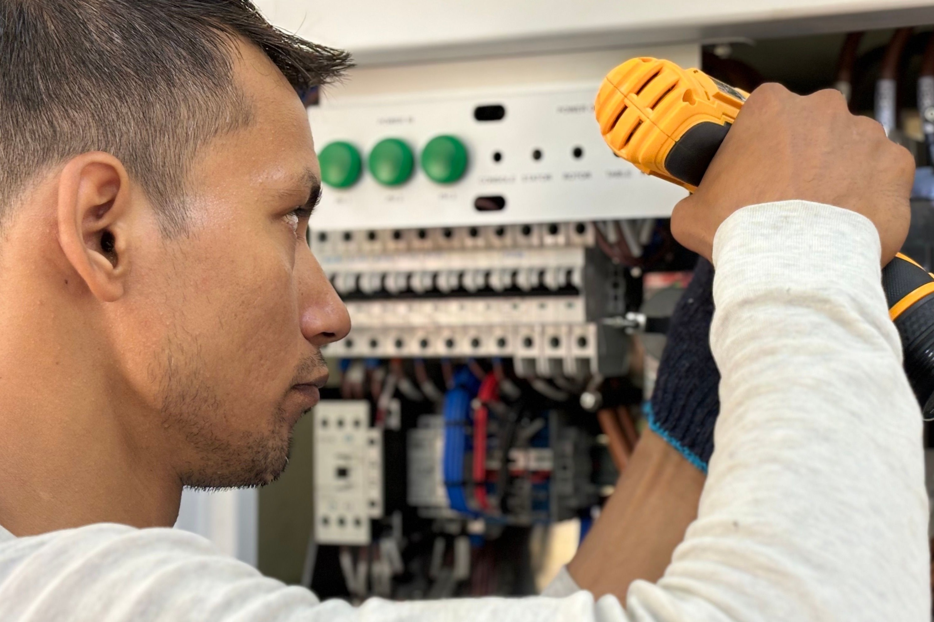 man working on electrical board