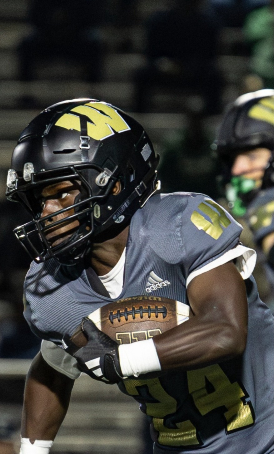 Running back carrying the ball in a football game