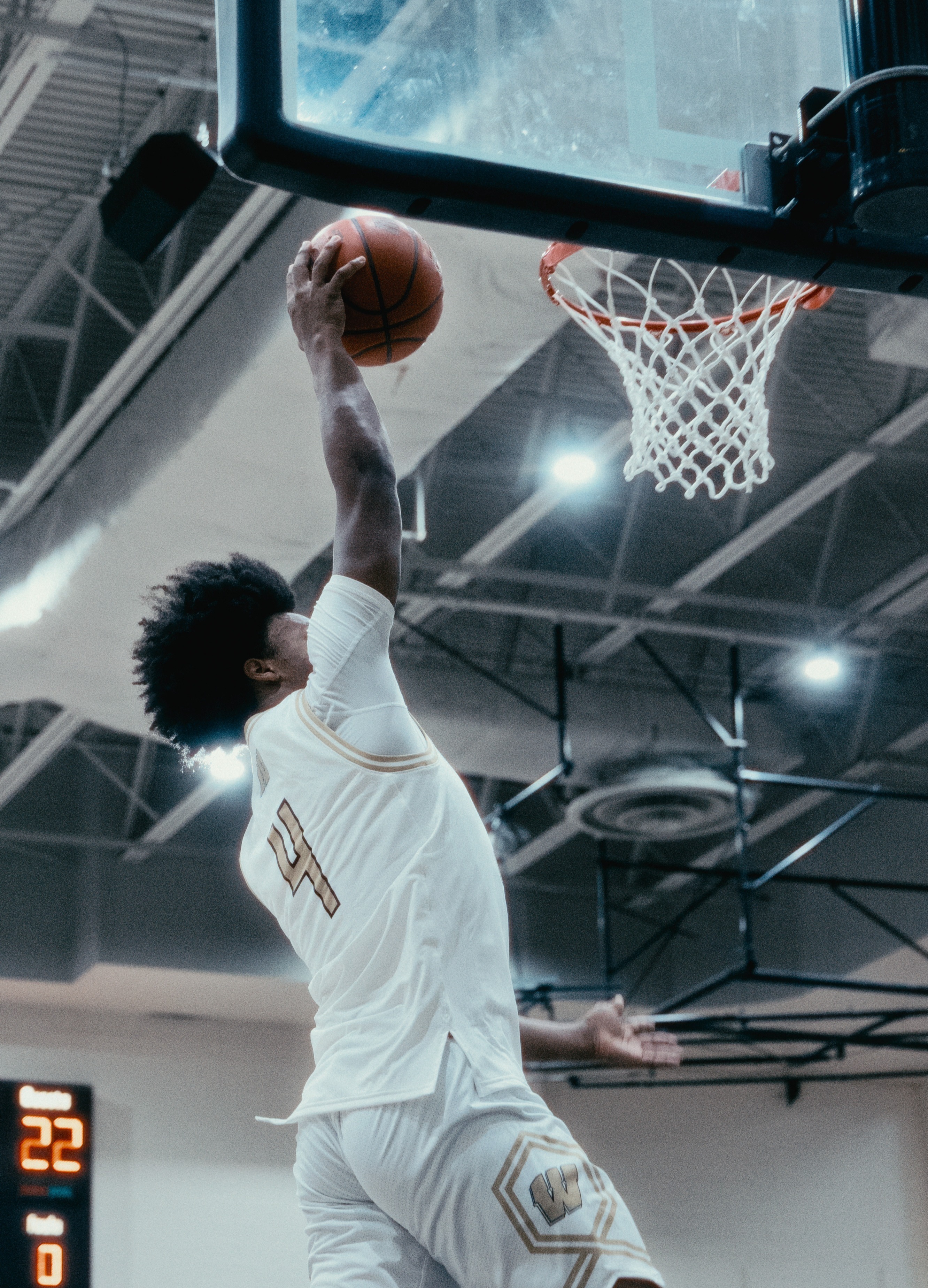 Student dunking a basketball in a varsity game