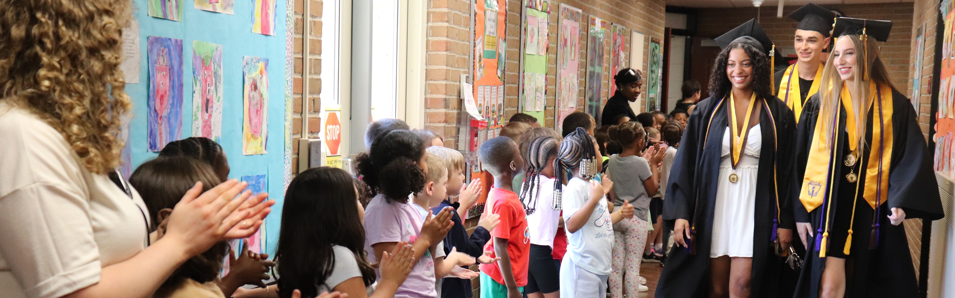 2026 Wood Creek Elementary Graduate Walkthrough, FPS Hich School Graduates Walking the halls of Woodcreek Elementary with elementary students lining the halls in applause