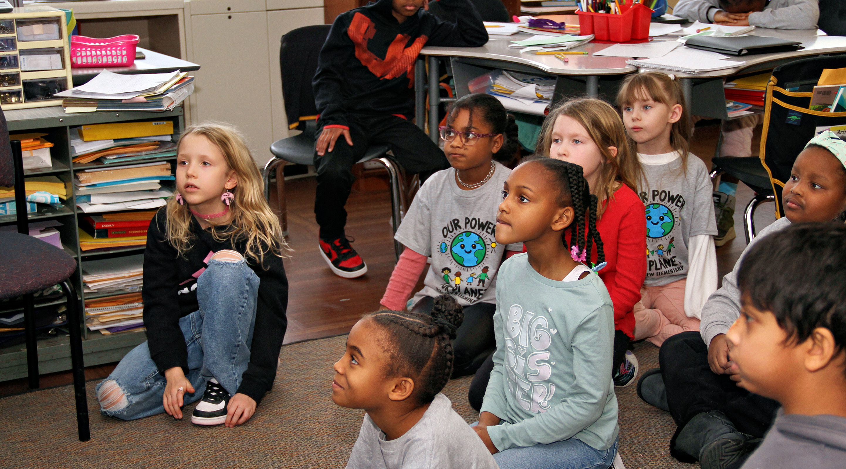 Beechview students sitting on the floor together in the classroom.