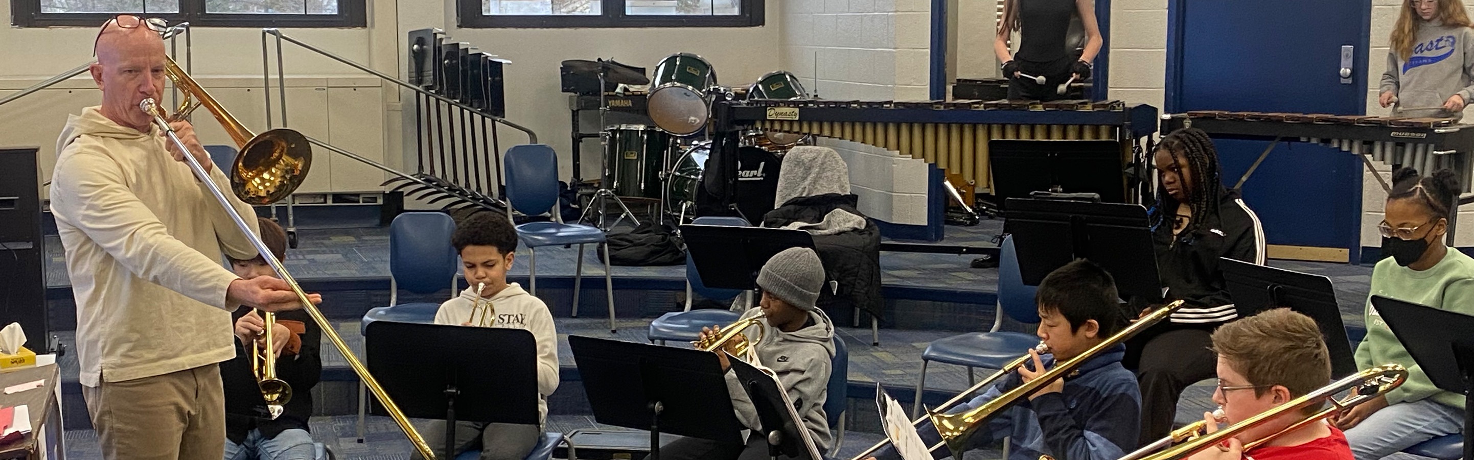 Middle School students in band class playing instruments.