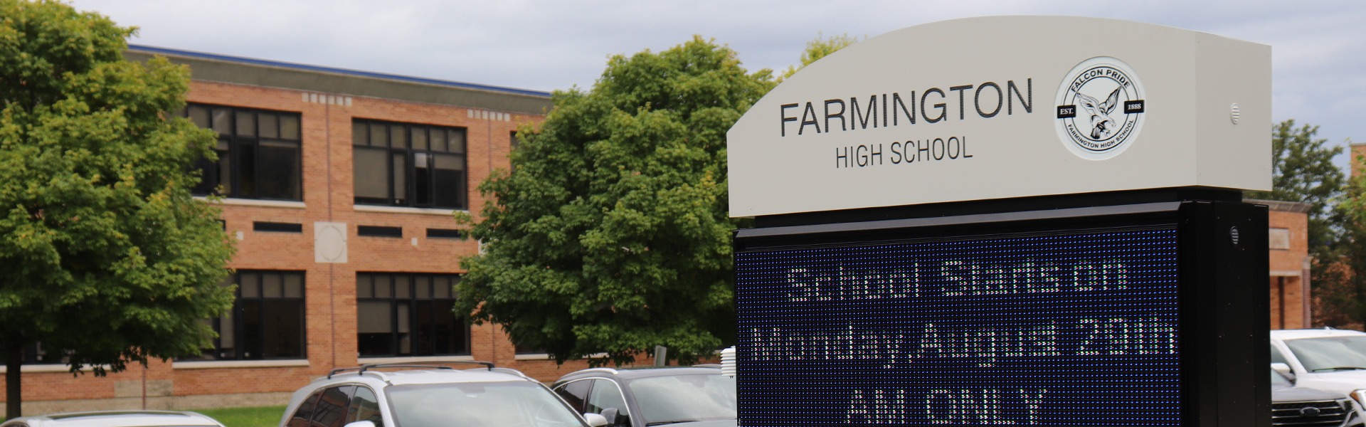 Farmington High School building with a digital sign announcing school starts Monday, August 29th, AM only.