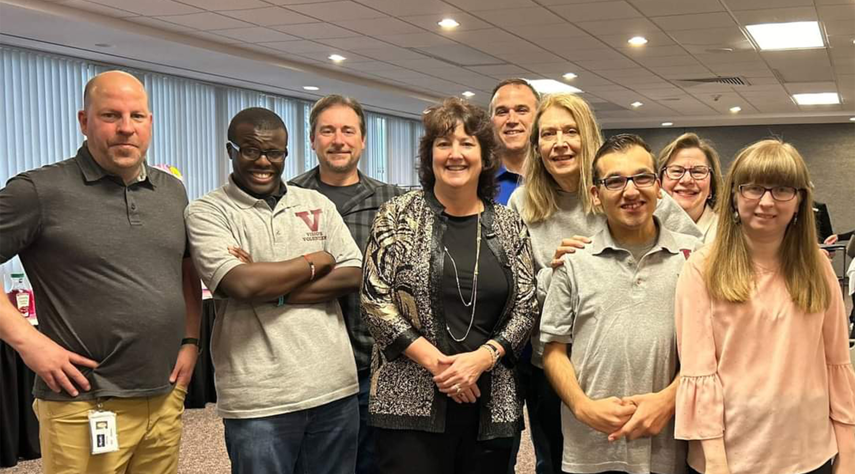 Visions students and staff looking at the camera and smiling
