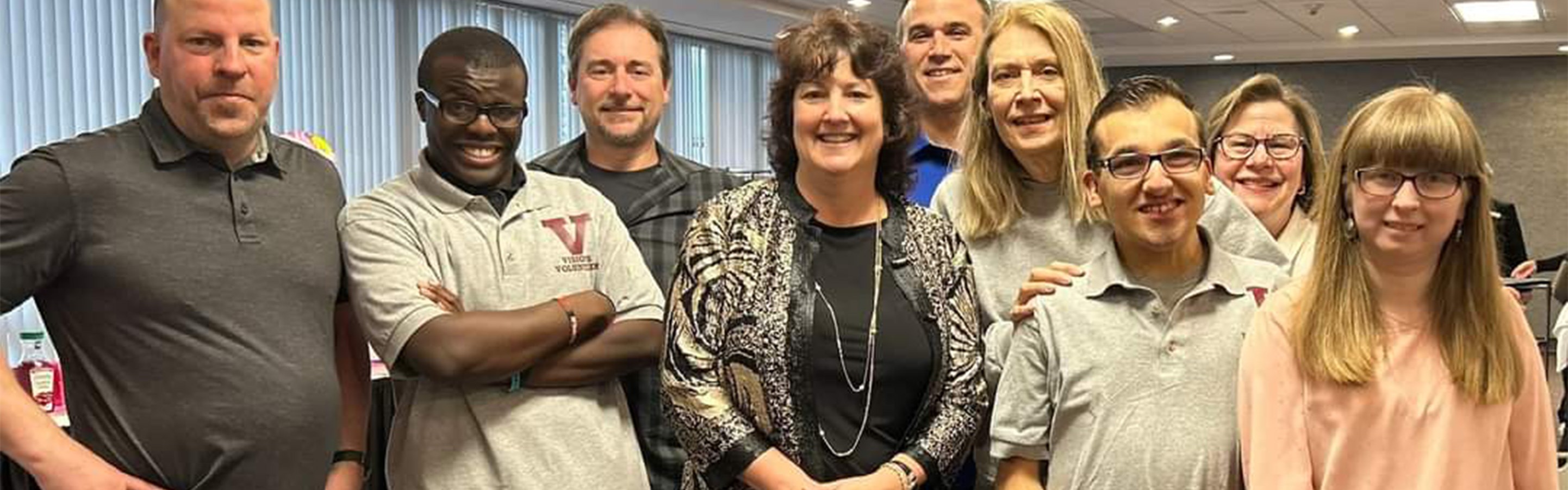 Visions students and staff looking at the camera and smiling