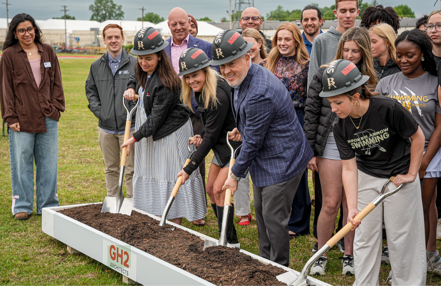 Superintendent and students with shovel