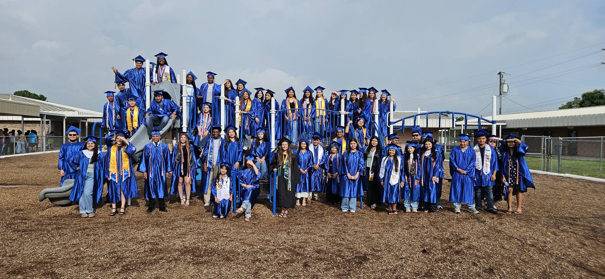 boys and girls in blue graduation cap and gowns