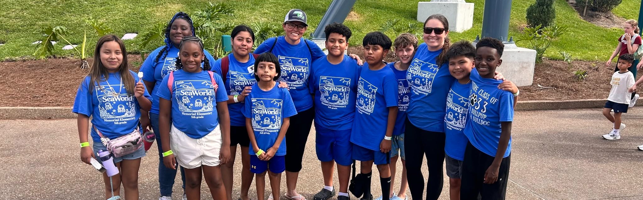 kids wearing blue shirts posign for picture