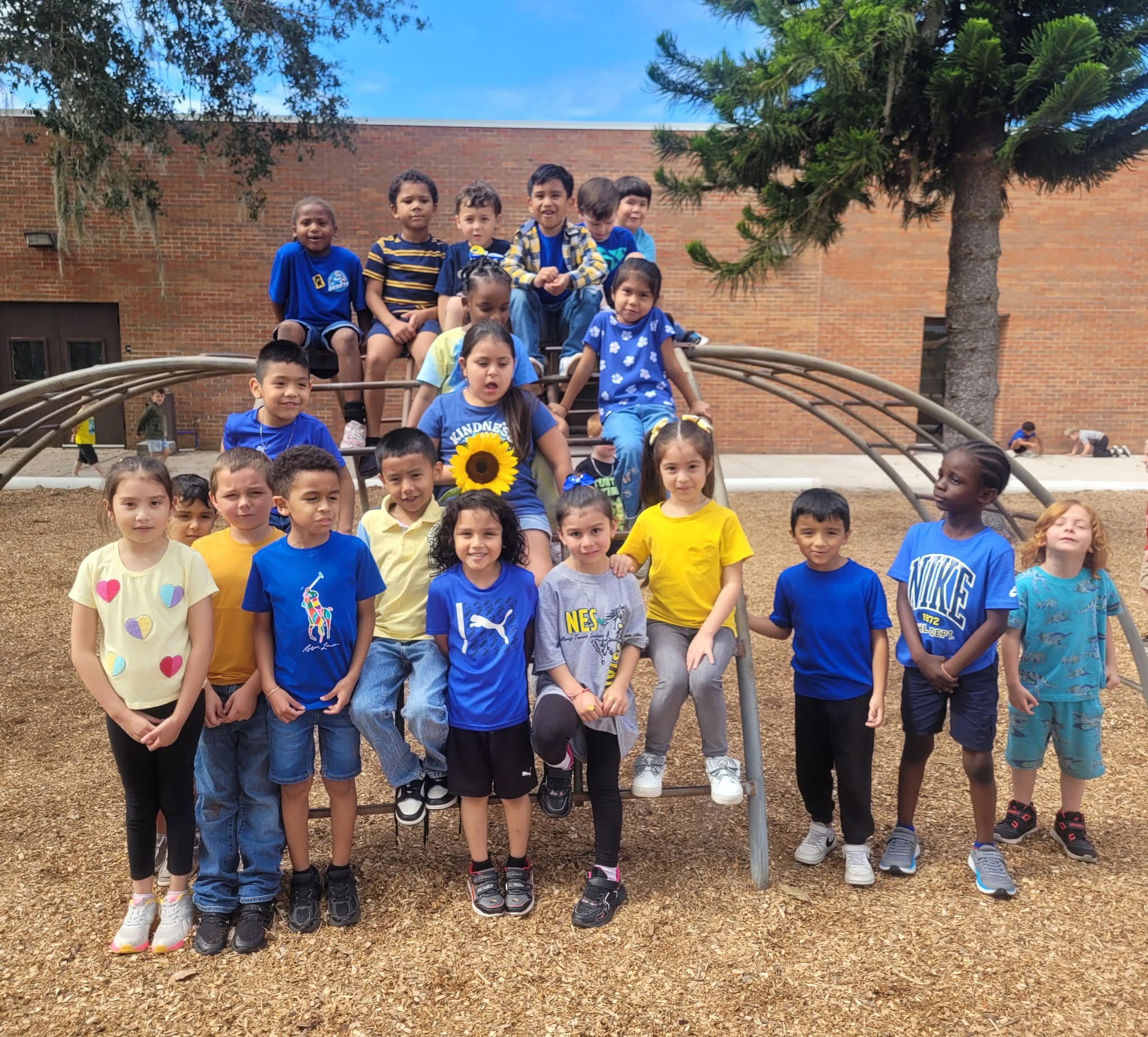 group of kids posing for picture on playground