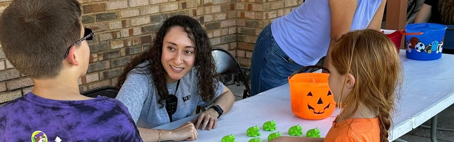 fall festival table with teacher adn students