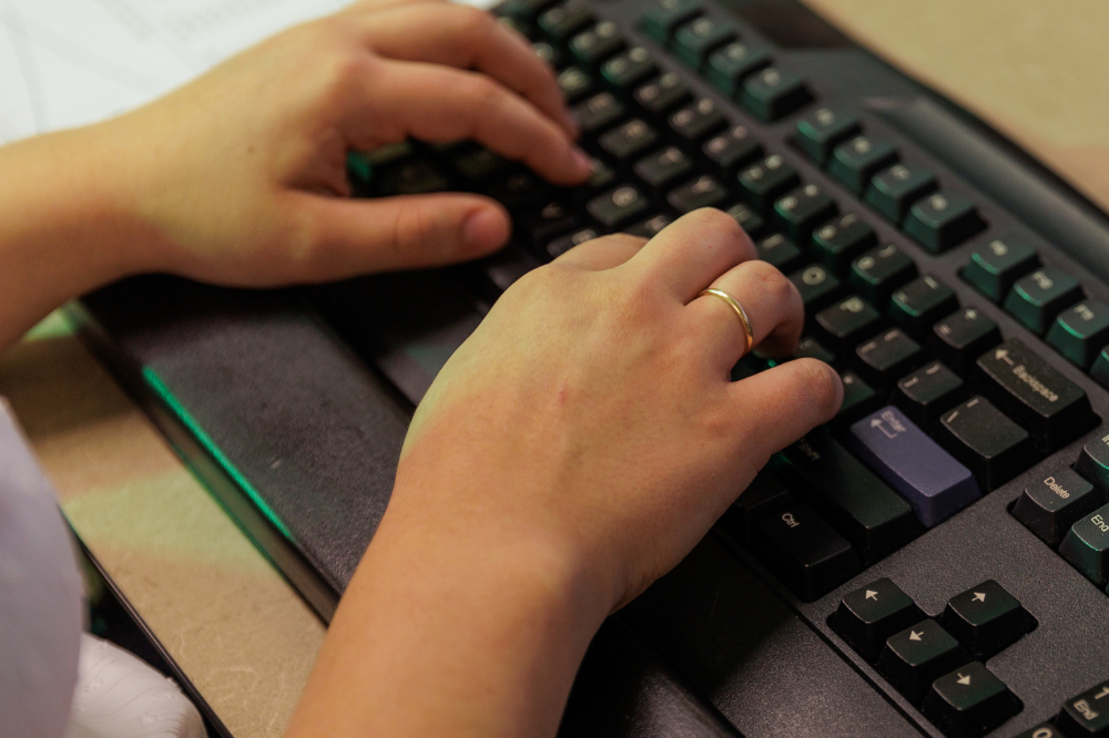 BET student typing on a keyboard. 