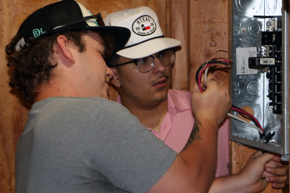 Electrical students practice running wires. 