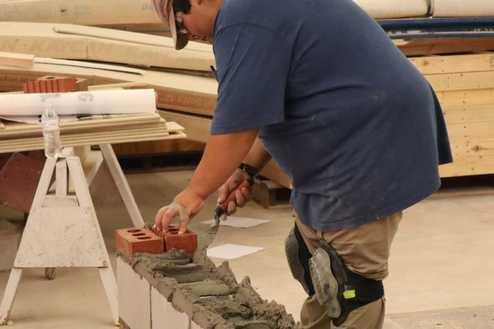 Student building a wall with bricks.