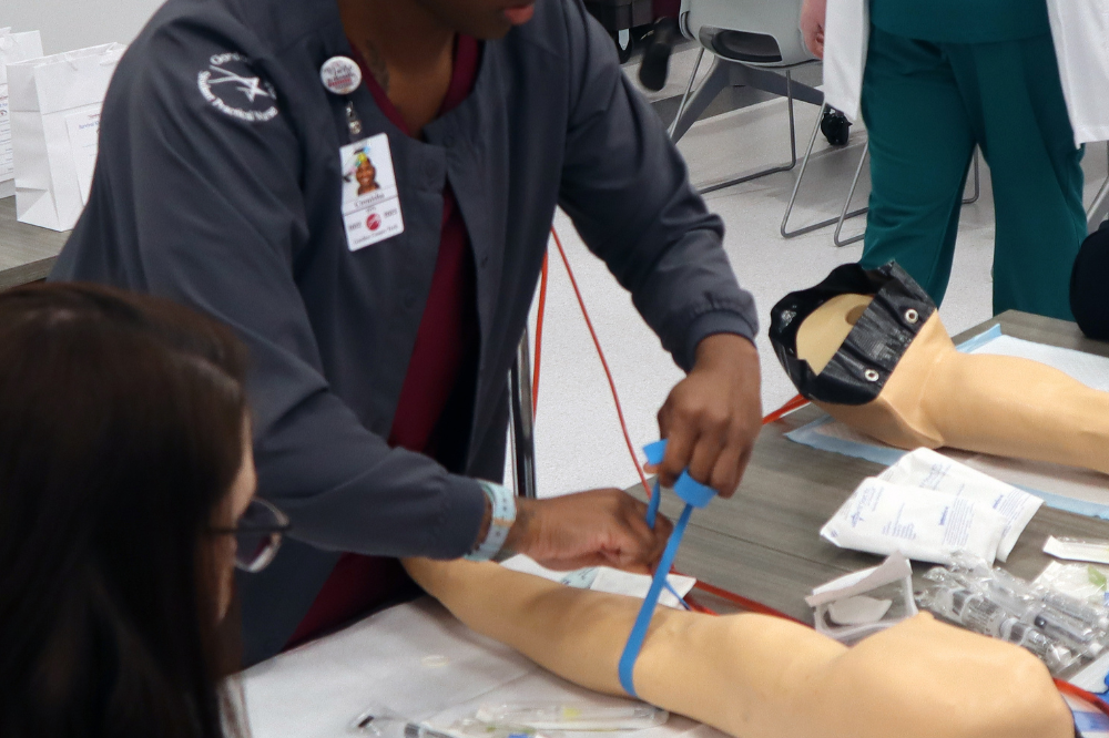 Practical Nursing student demonstrates how to draw blood.