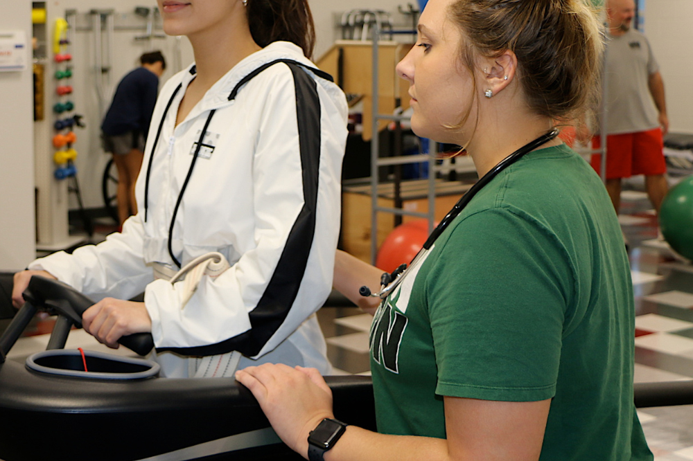 PTA student observes patient on a treadmill.