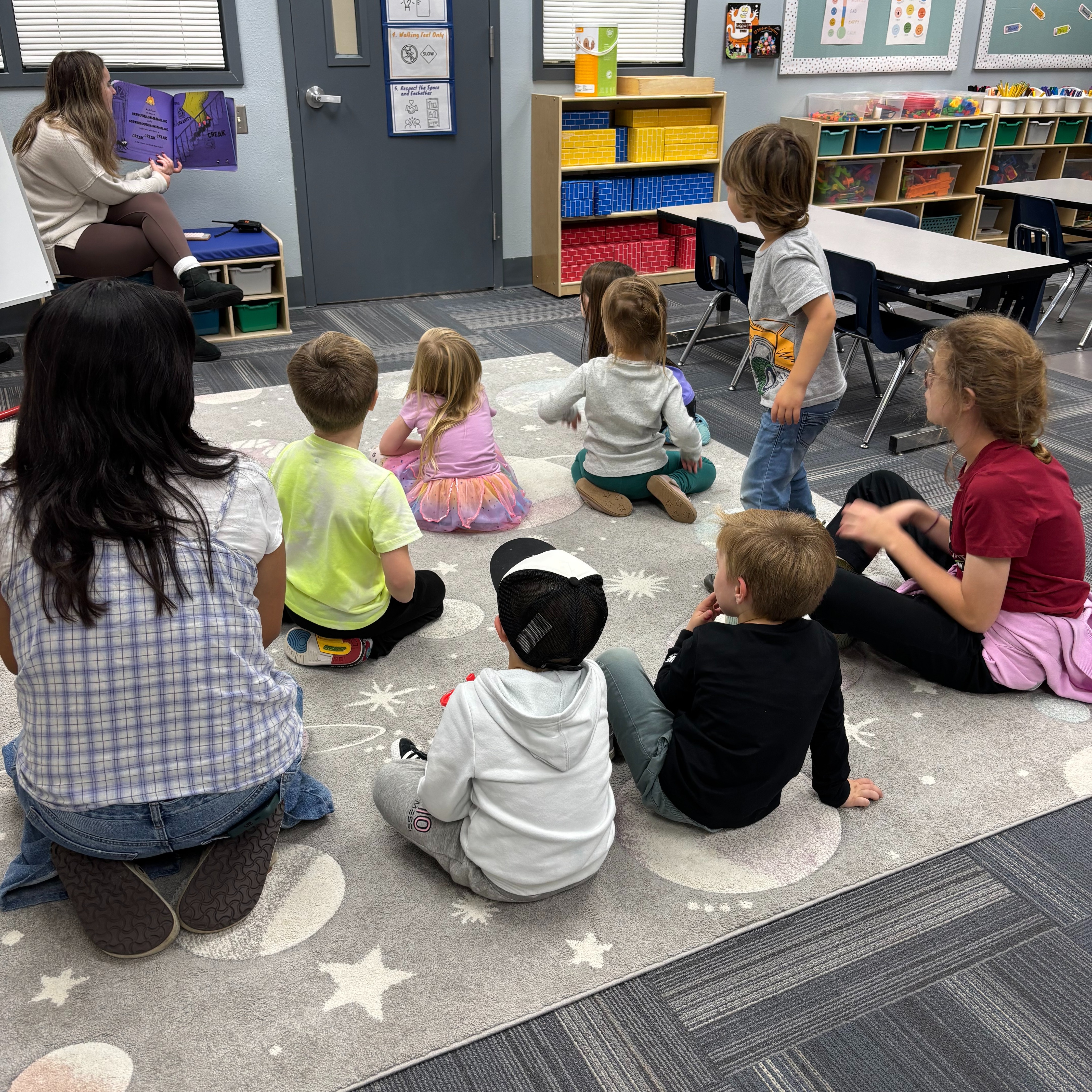 A group of children sitting and listening to a story.