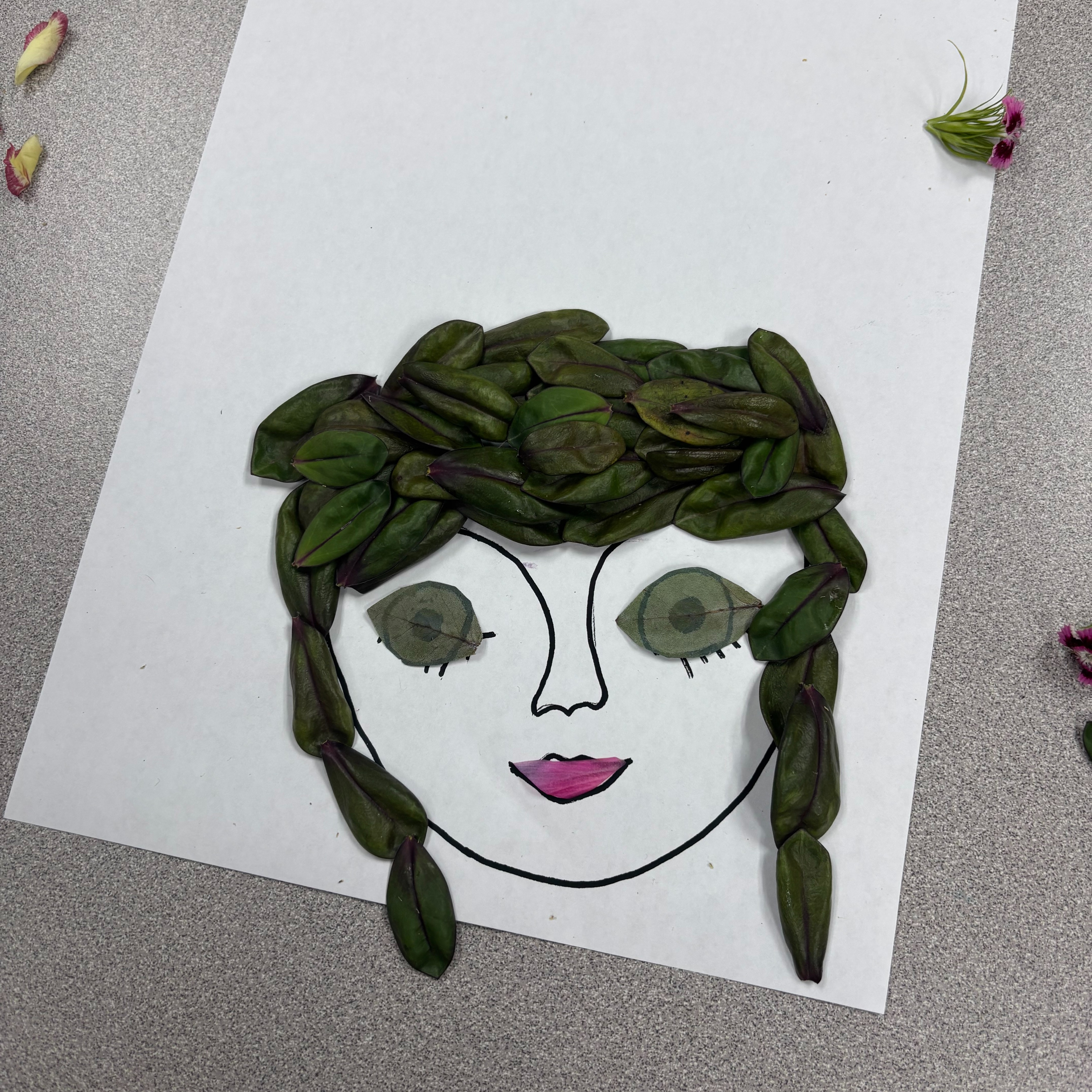 Flower Art using a face outline and flower petals.