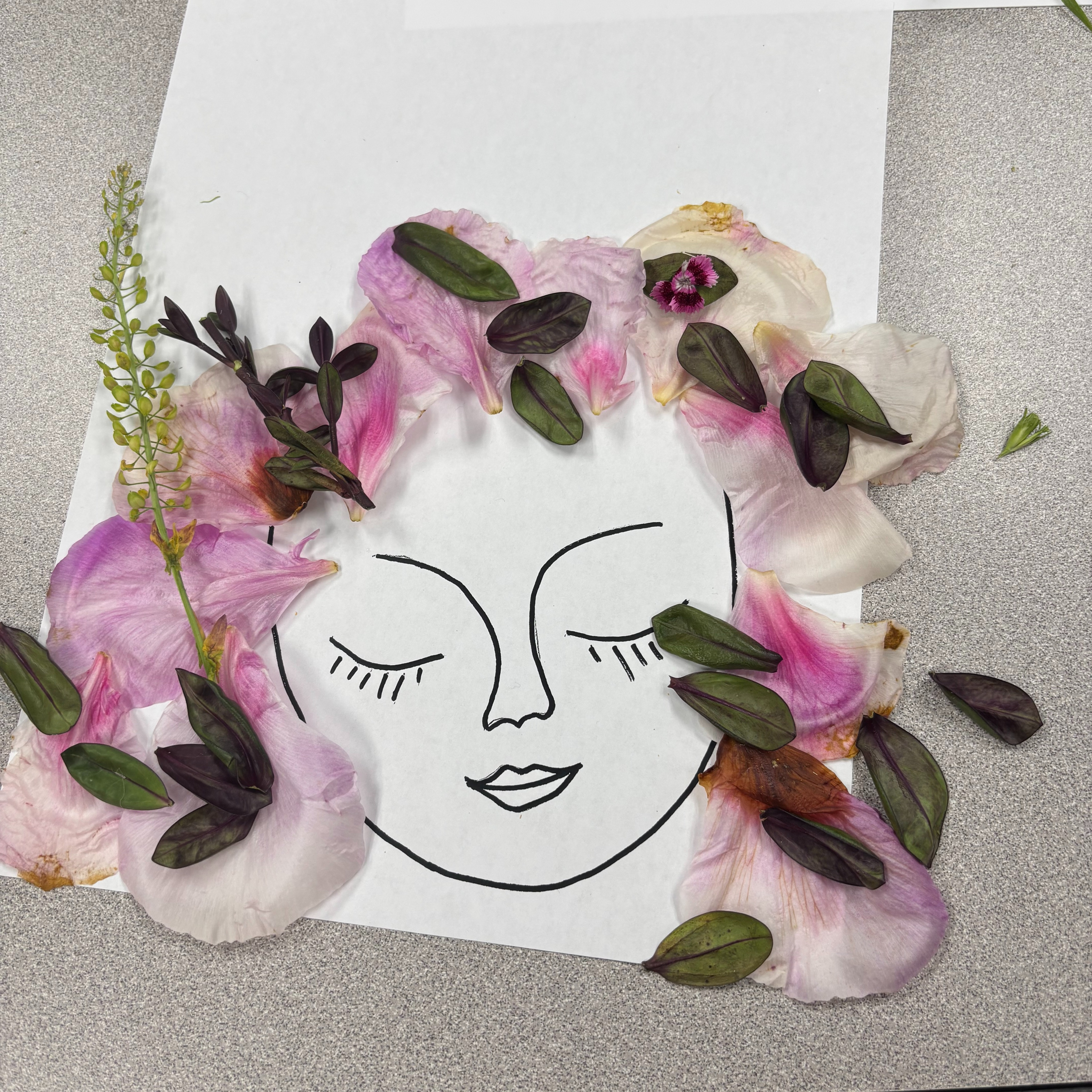 Flower Art using a face outline and flower petals.