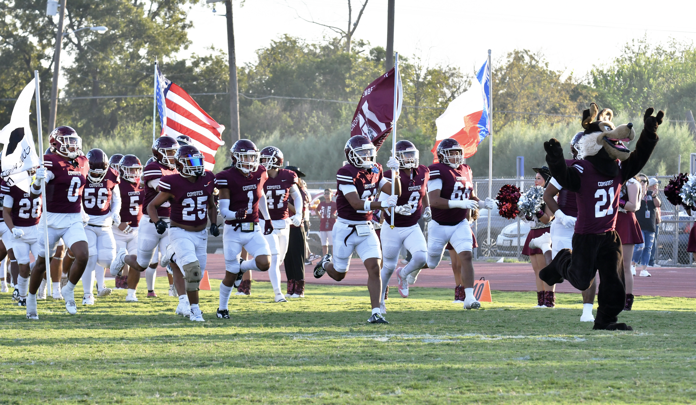 football players running onto the field