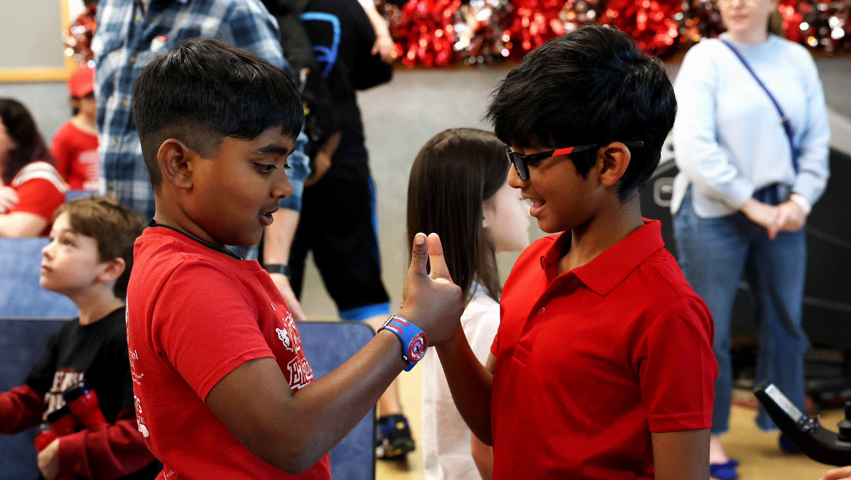 Two young boys having a thumb war