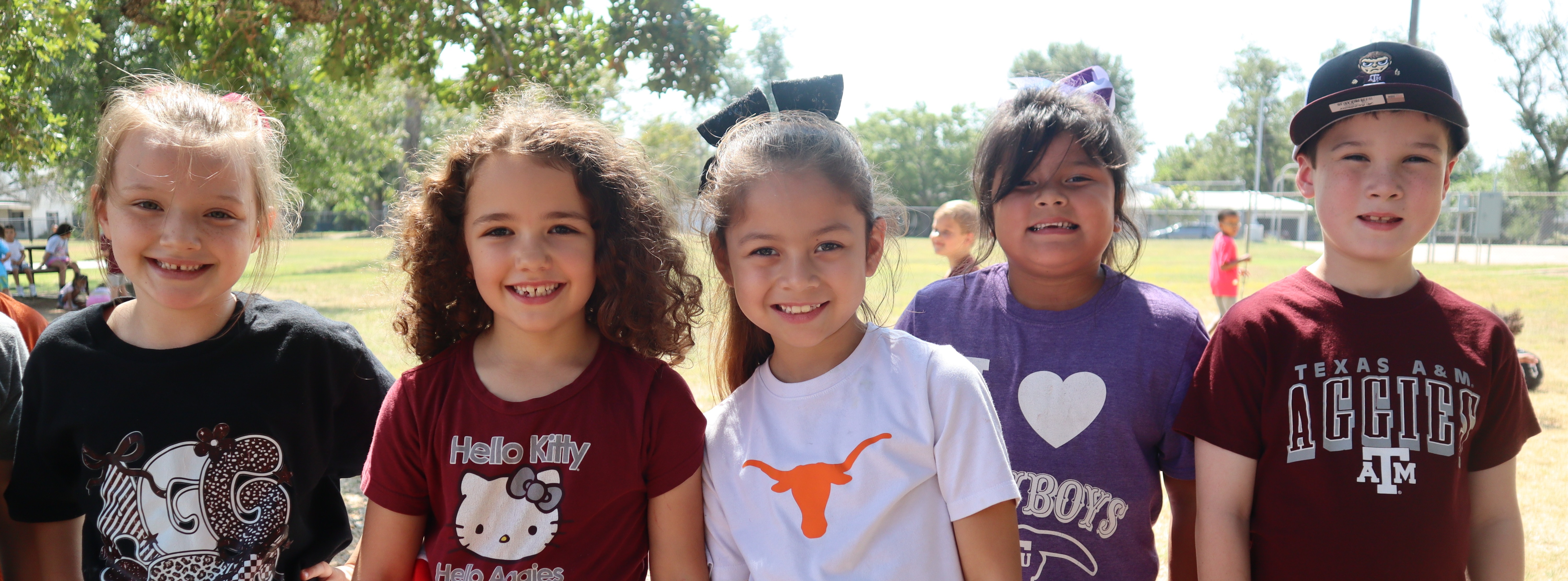 Five students standing and smiling