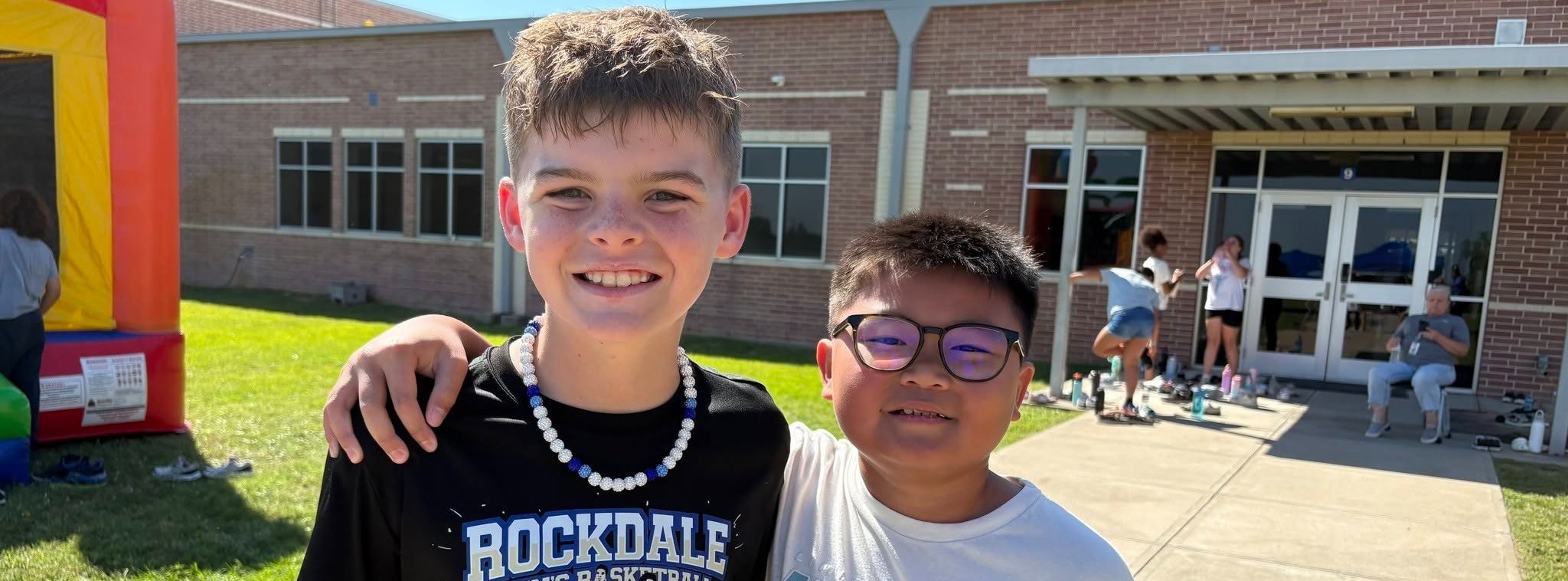 Two students standing together and smiling