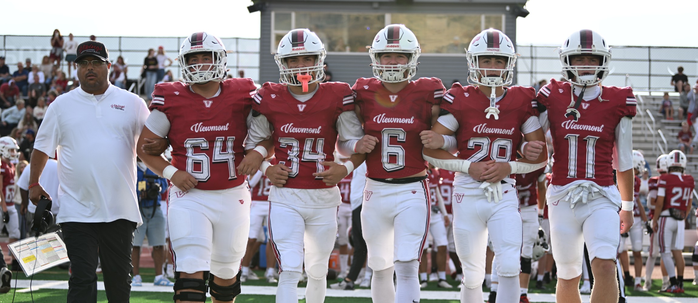 football team captains in uniform walking out on the field