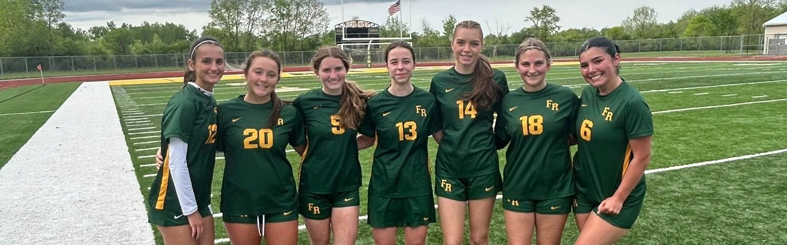 Girls soccer athletes posing. 