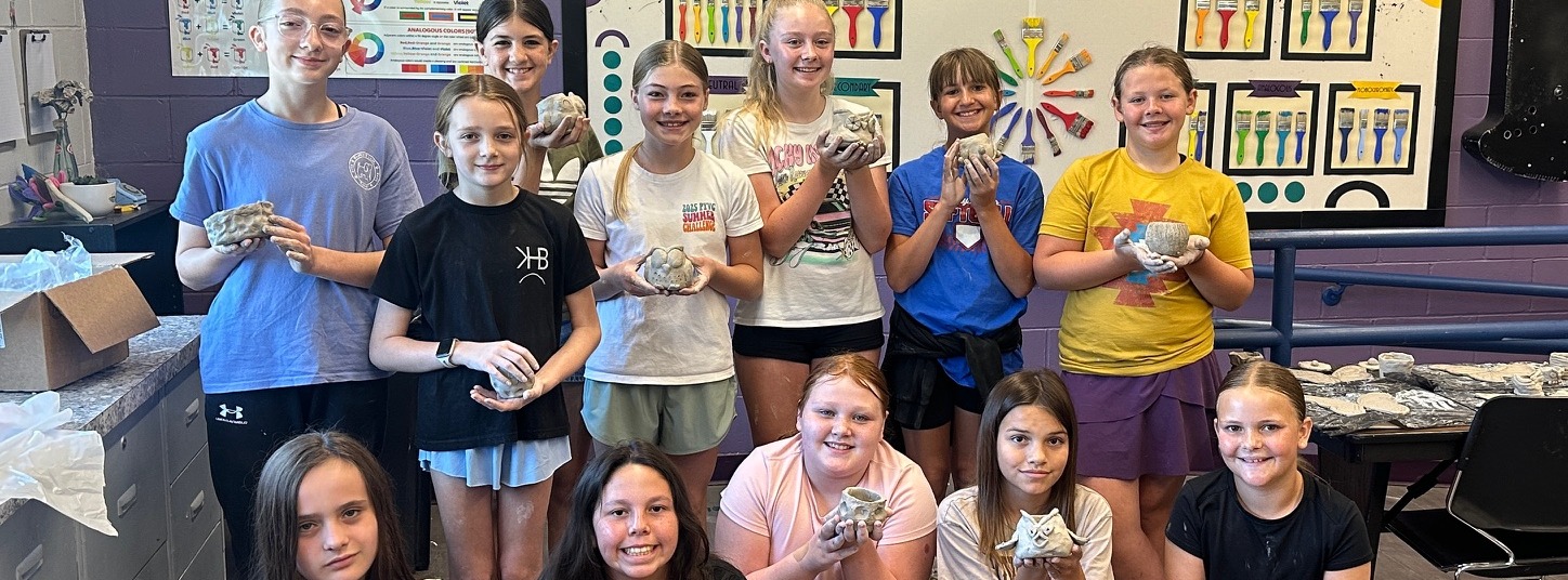 kids with their pottery creation during Middle School Summer Programming
