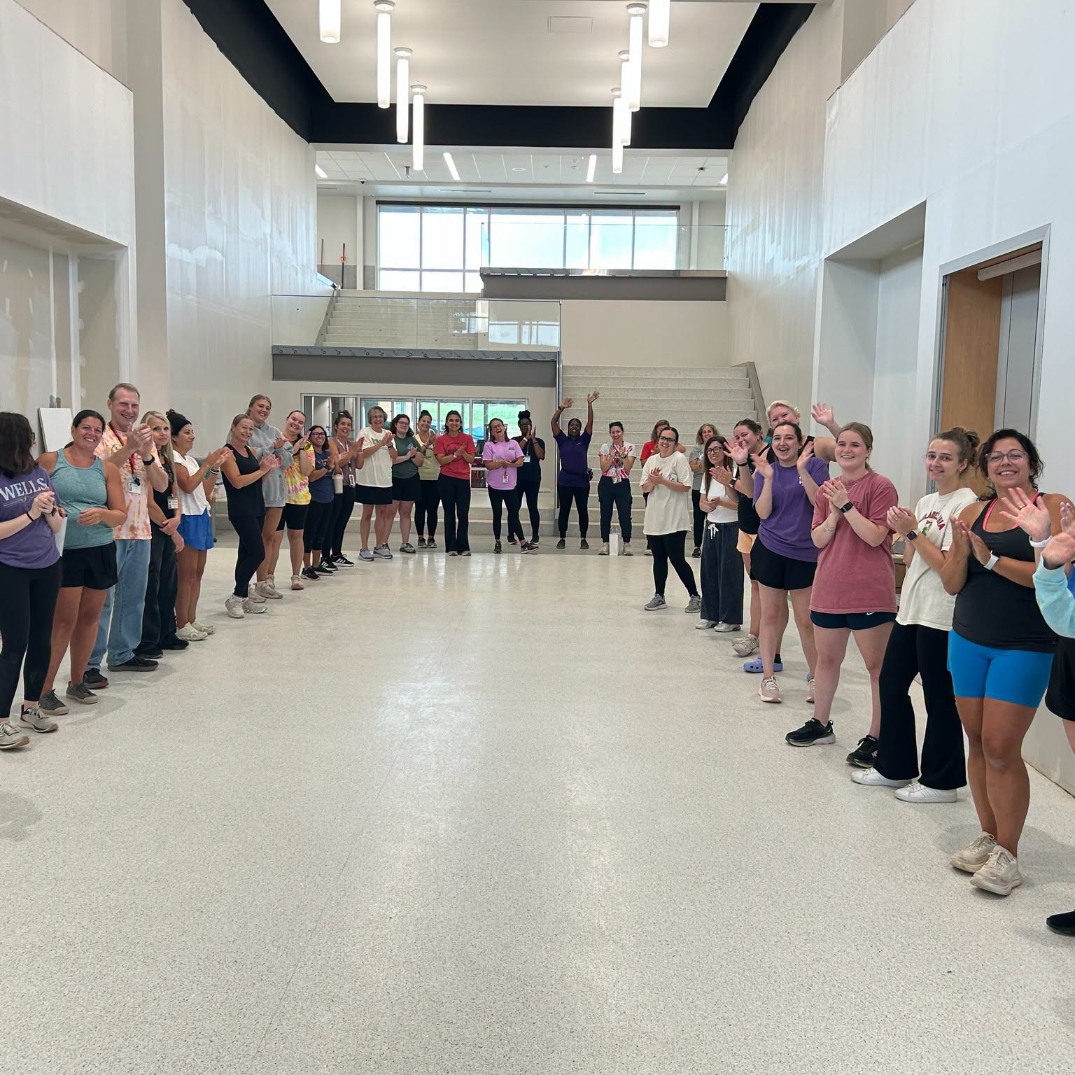teacher line up in new building smiling