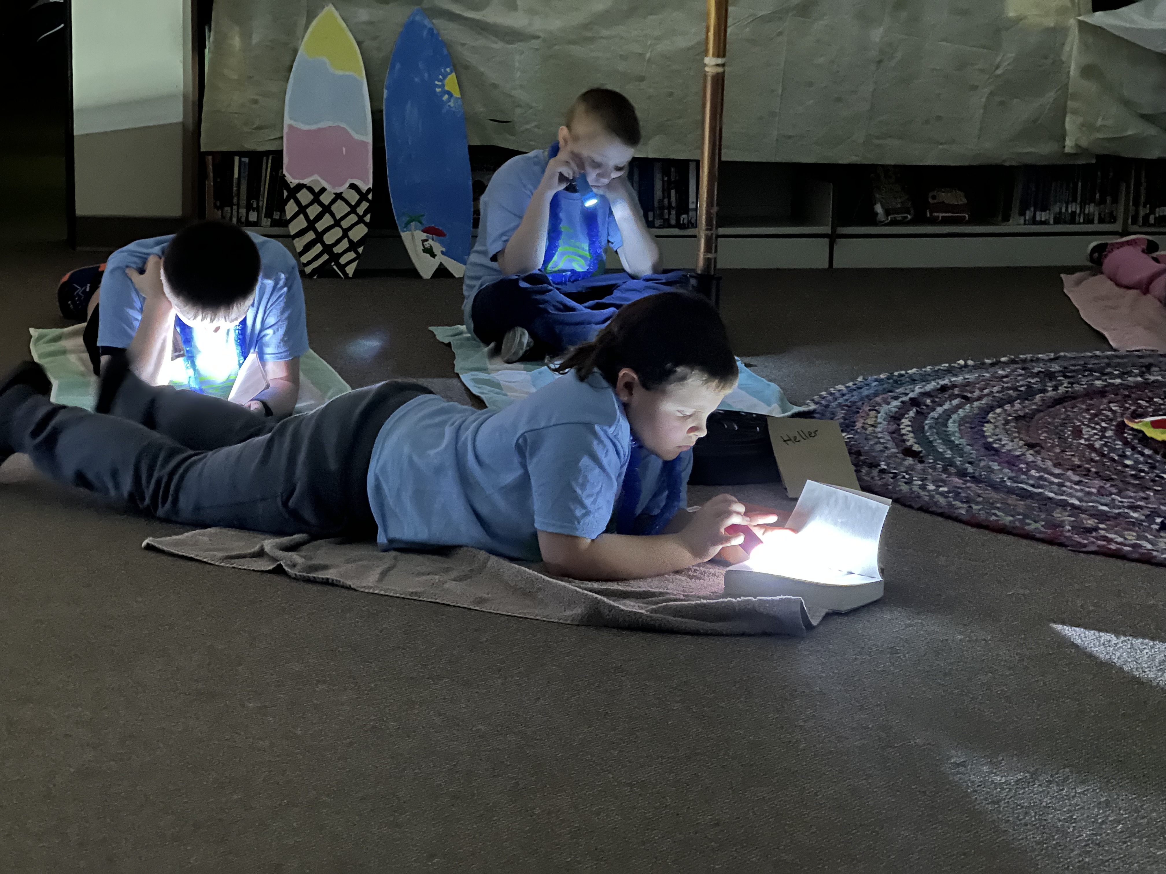students using their flashlights during one of the reading sessions