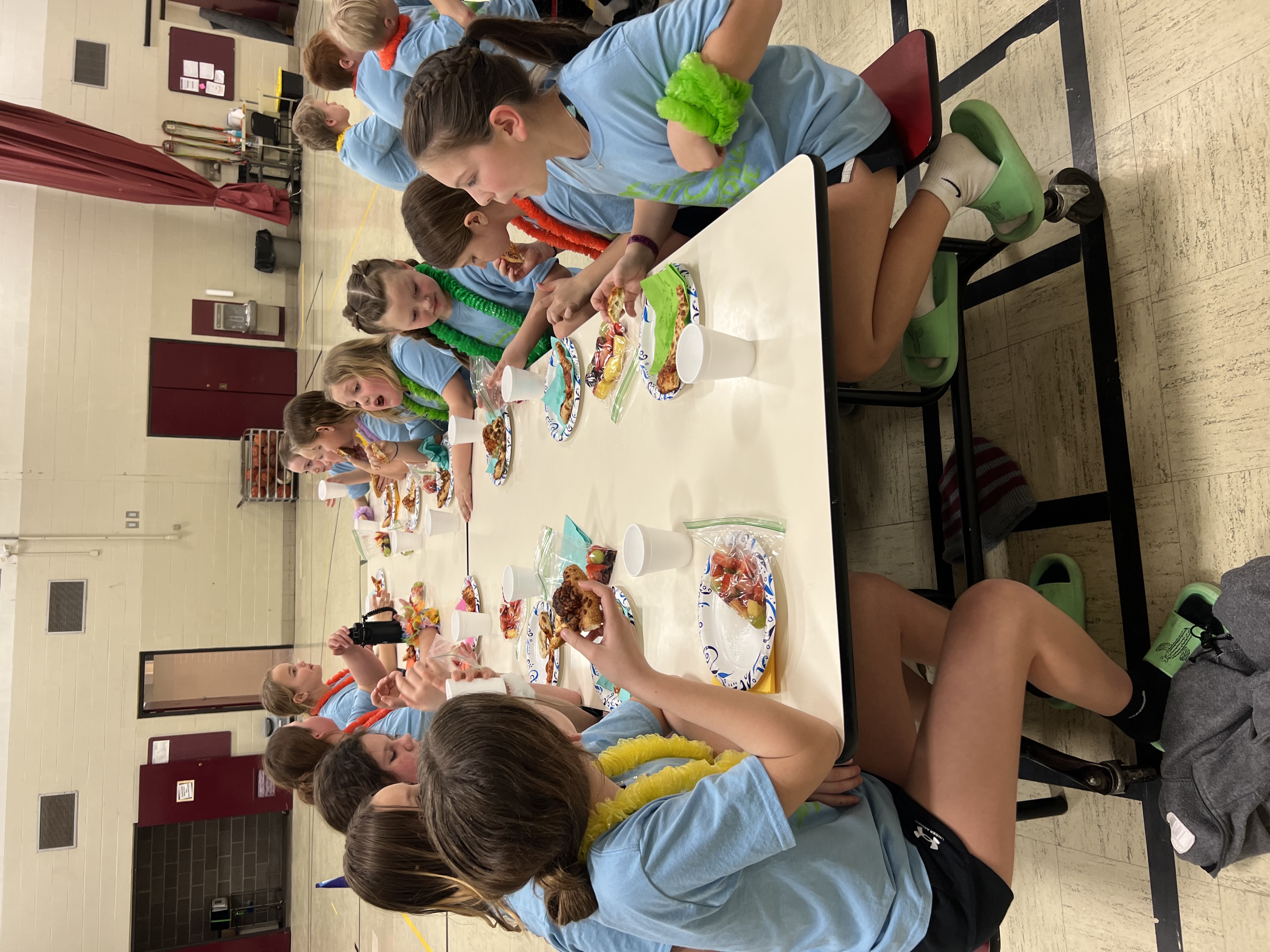Students enjoying some pizza and fruit for a late night snack