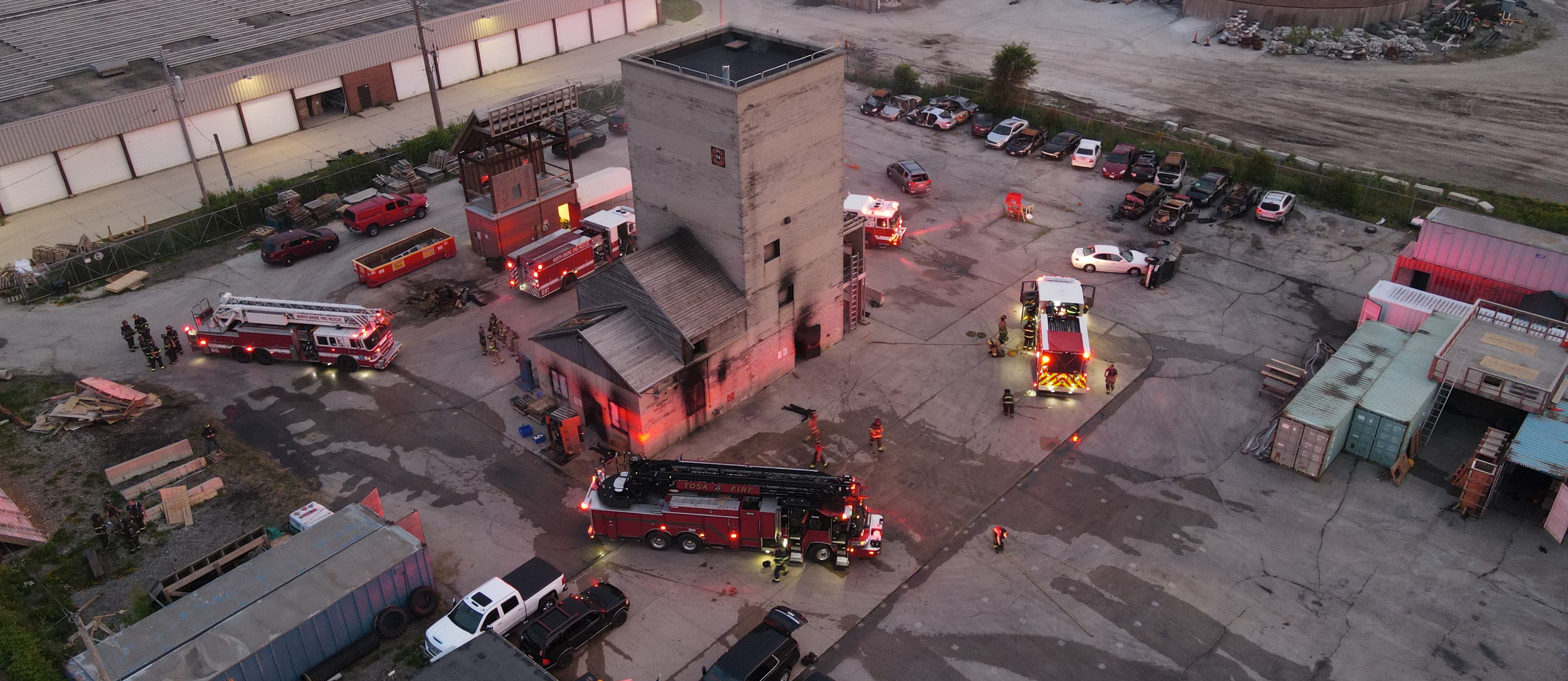 drone view of the fire training grounds with multiple fire trucks and people