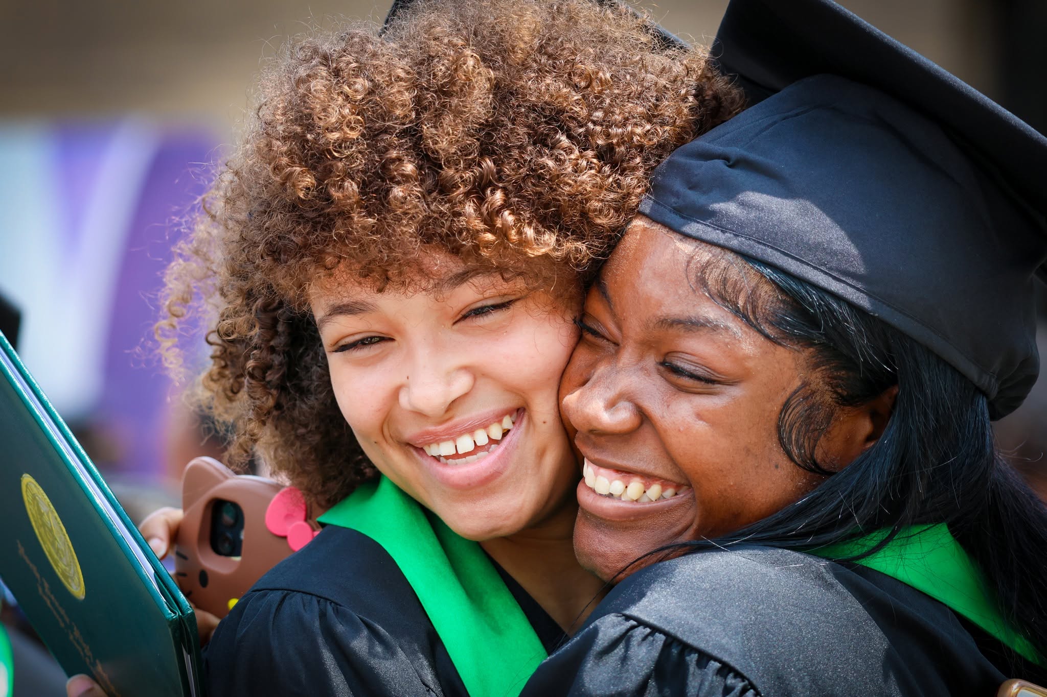Two girls from NLHS are seen hugging after graduation.
