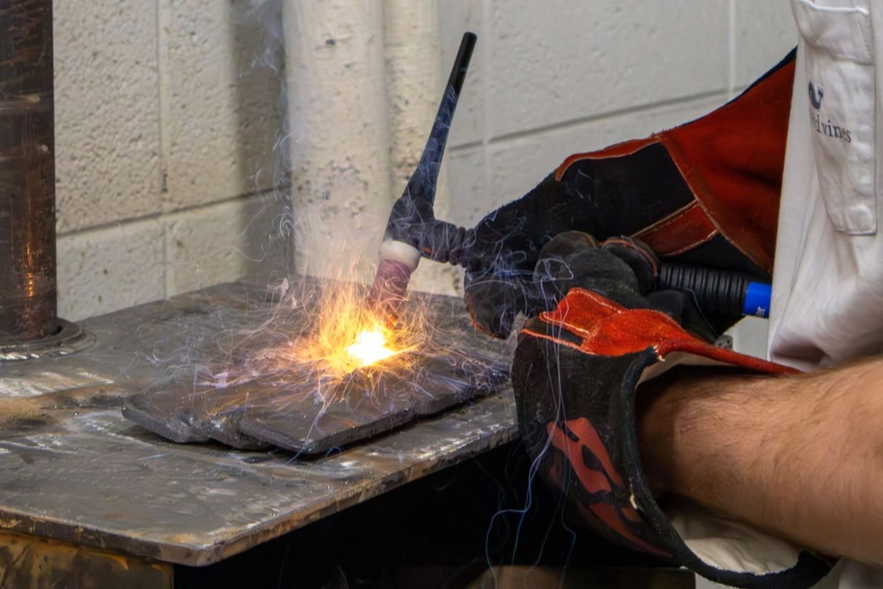 A student practices welding