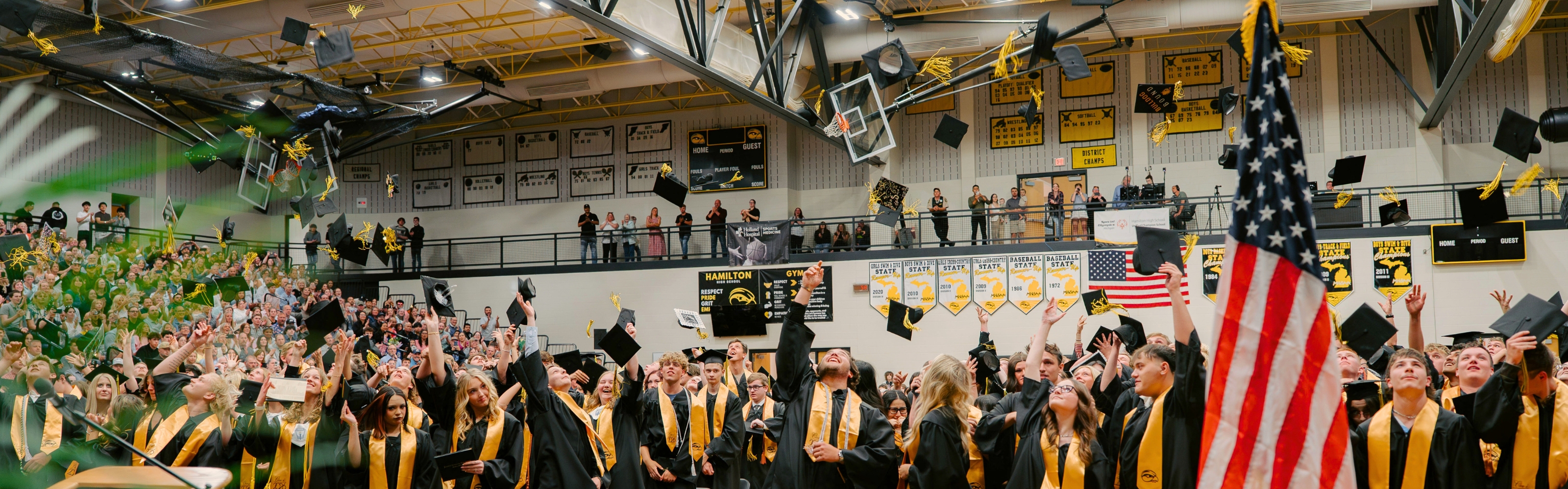 The Hamilton High School Class of 2026 throws their caps in the air after graduating.
