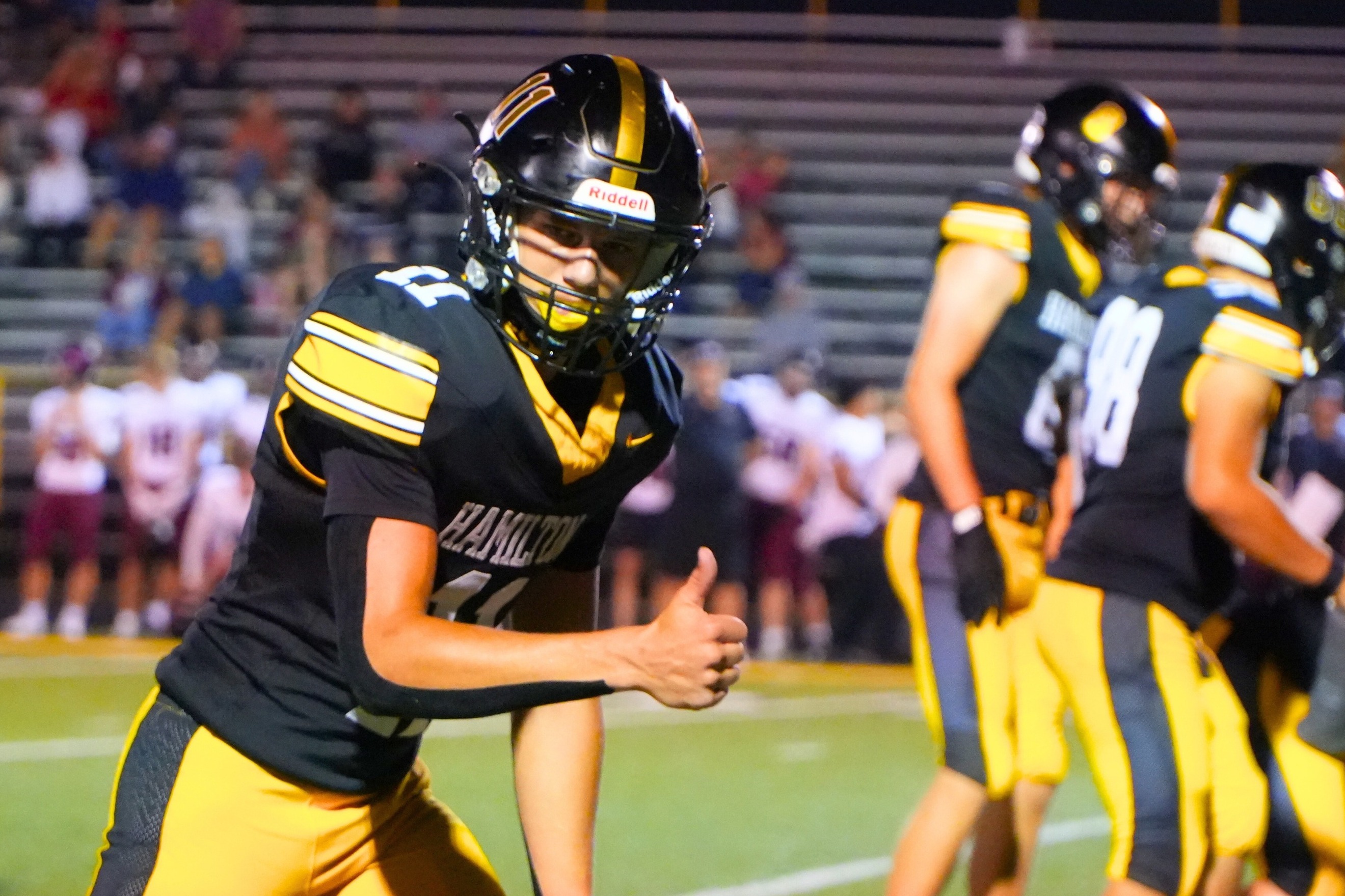 A football player gives thumbs up before a play.