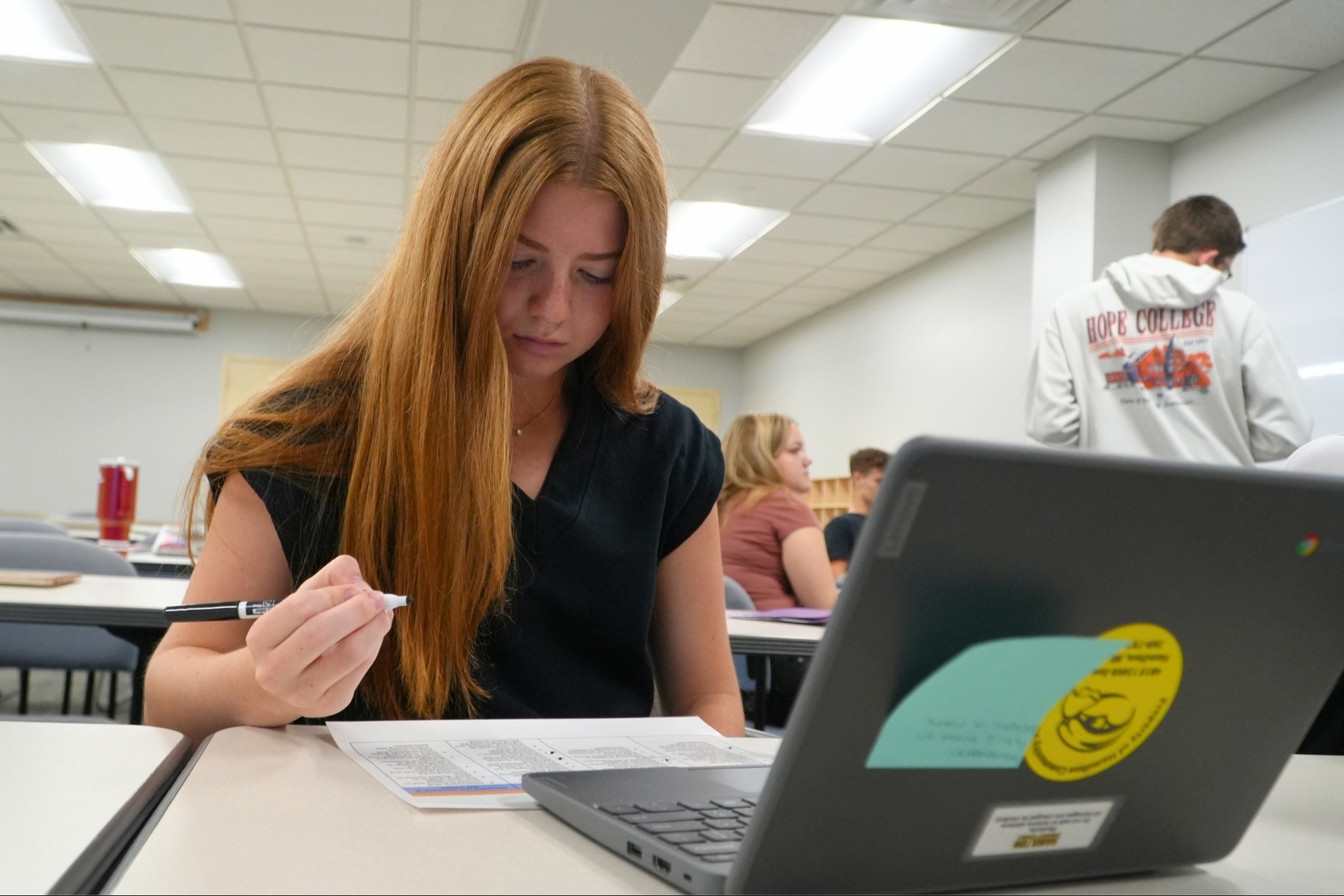 A female student learns in a college setting.