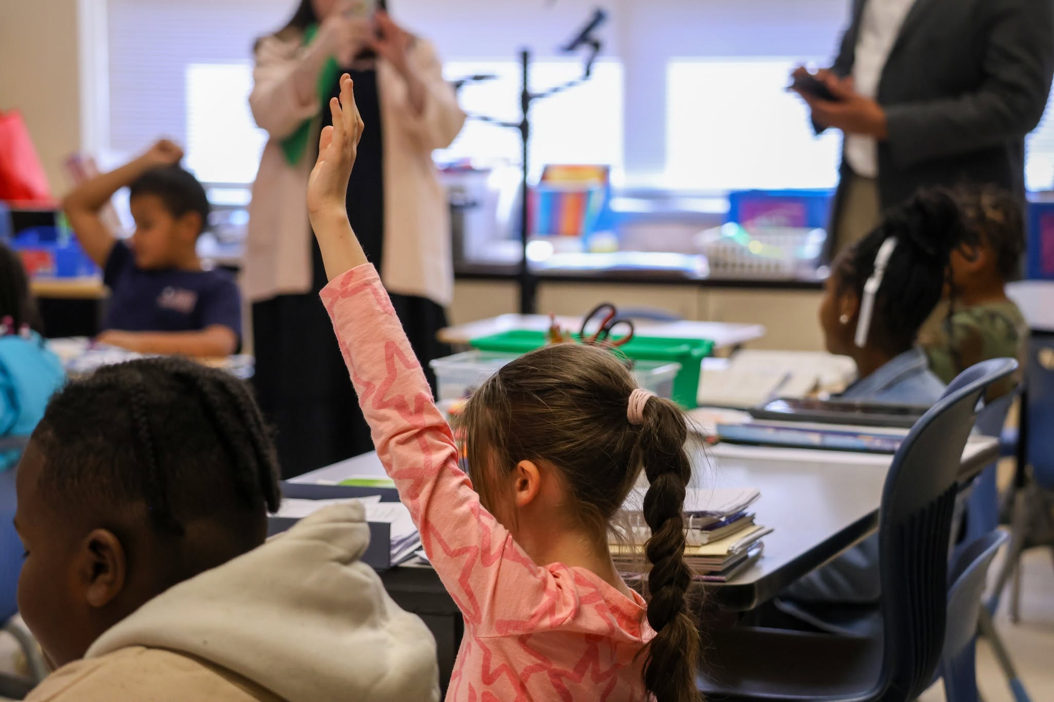 a student raises her hand in class