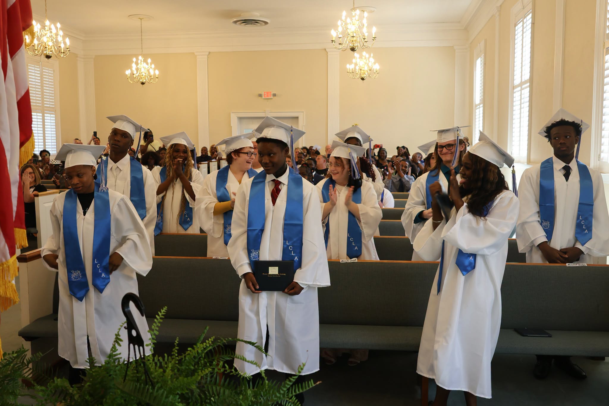 students at graduation turn their tassles