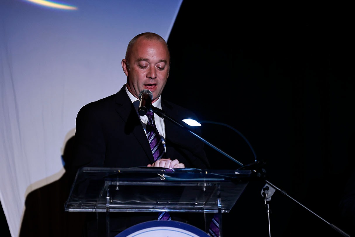 Foundation Board Chair stands at podium speaking