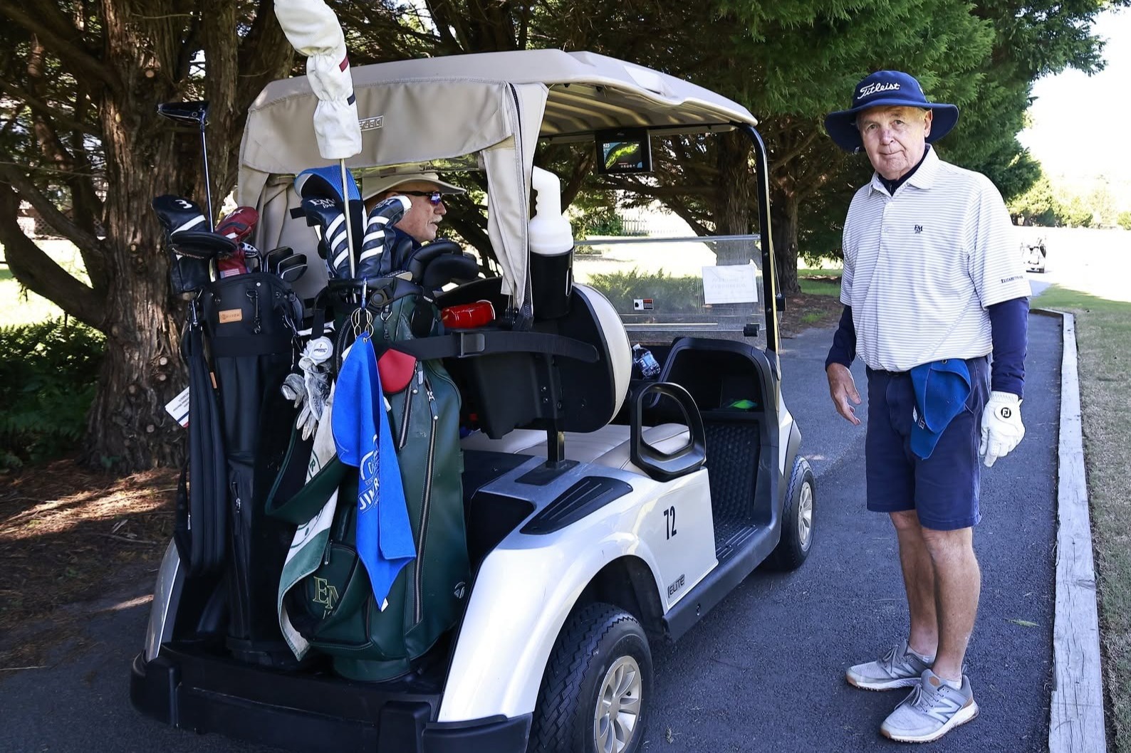Man standing next to a golf cart