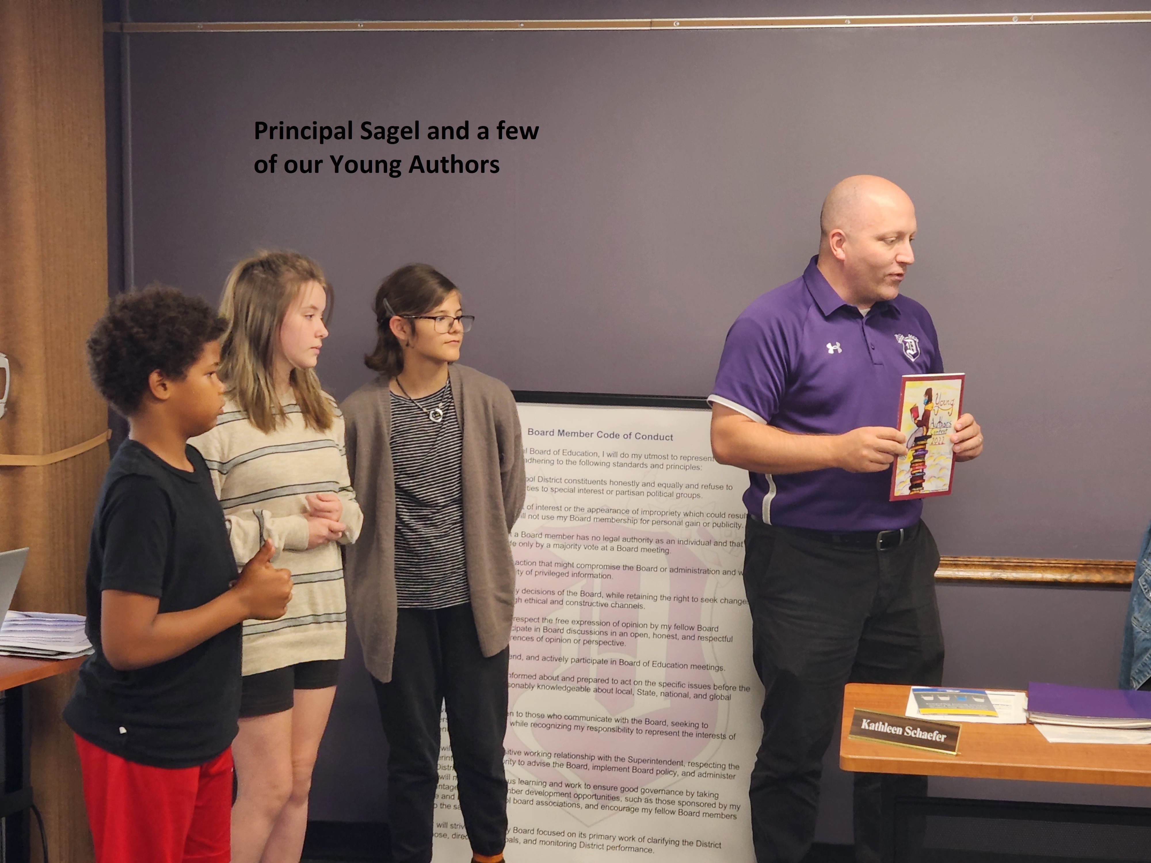 Photo of Principal Sagel and 3 of our young authors